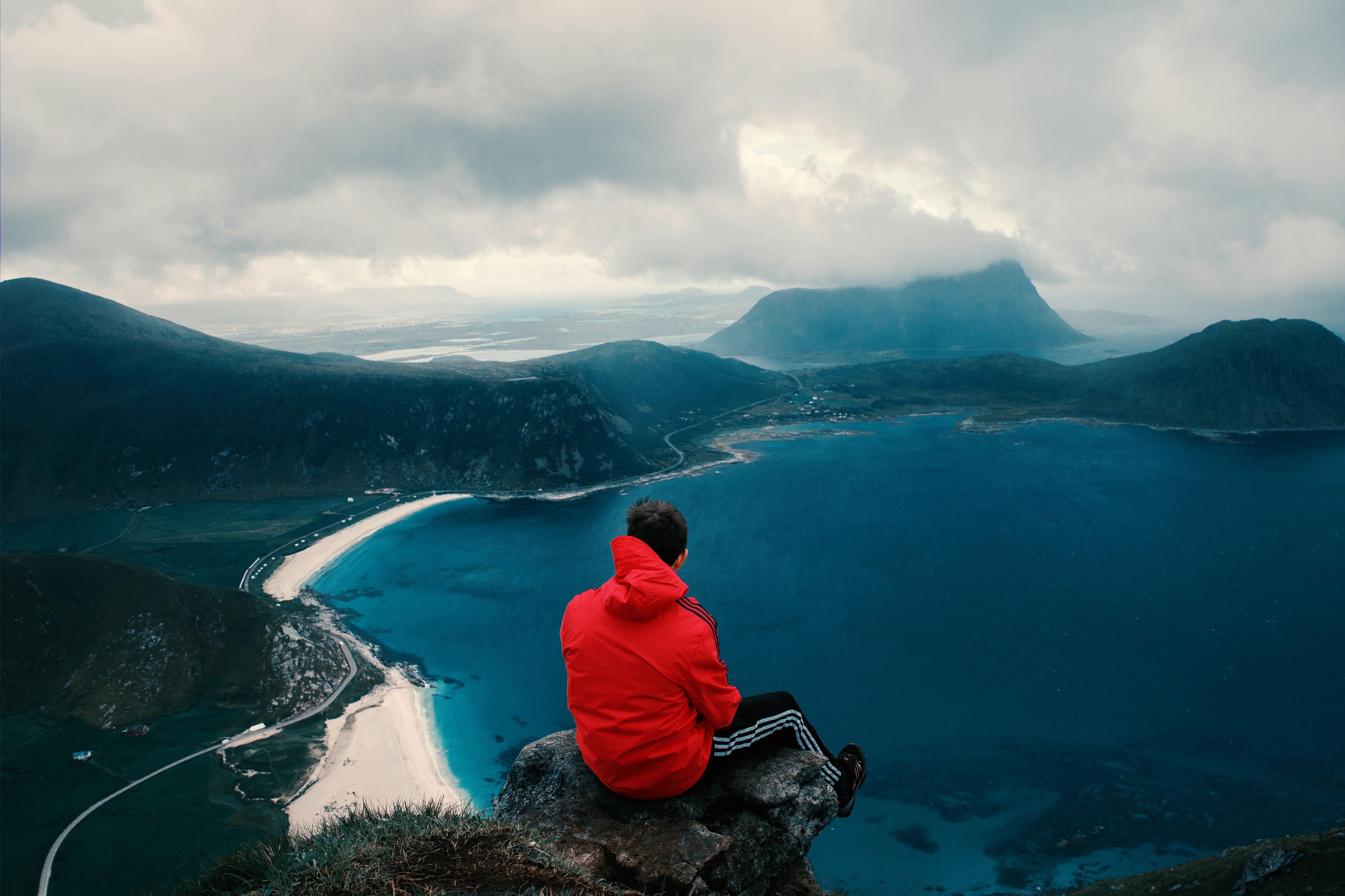 person sitting across body of water